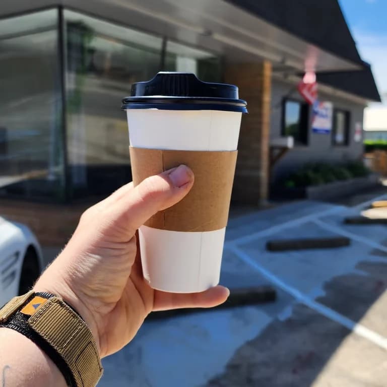 Coffee from Anchor Point Cafe held outside The Rock