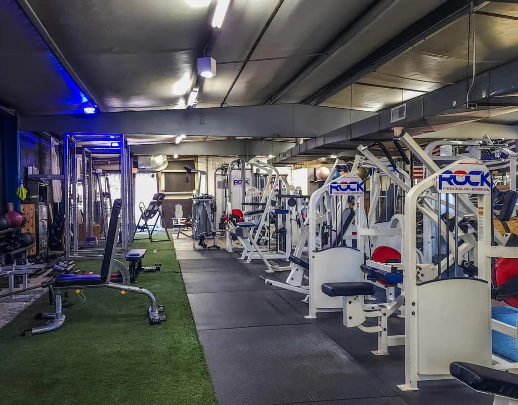 Strength equipment and turf on The Rock gym floor